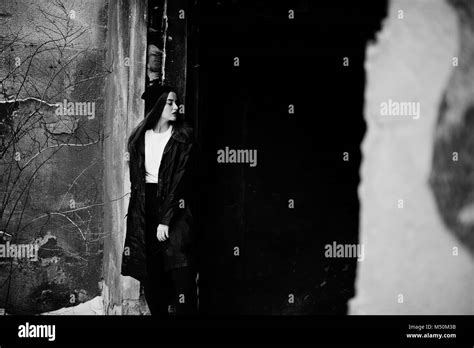 Fashionable Long Legs Brunette Model In Long Black Cloak Posed Outdoor At Winter Day Against Old