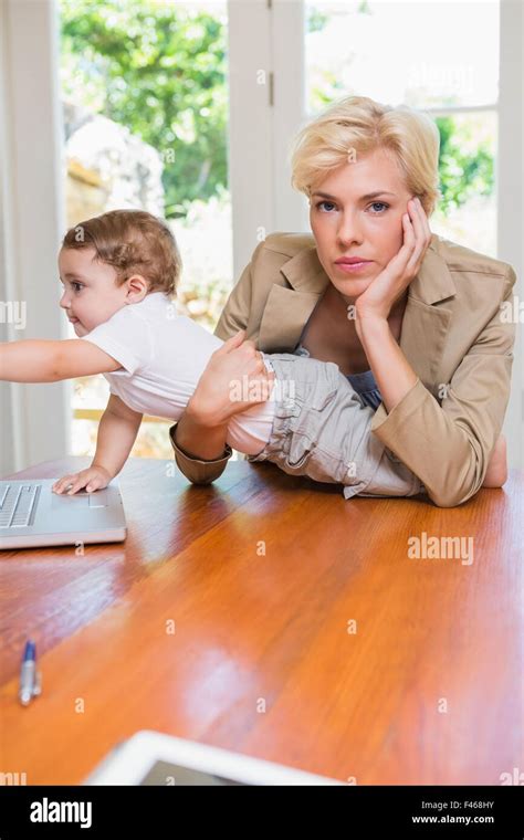 Blonde Woman With His Son Using Laptop Stock Photo Alamy