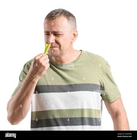 Mature Man With Clothespin On White Background Stuffy Nose Concept