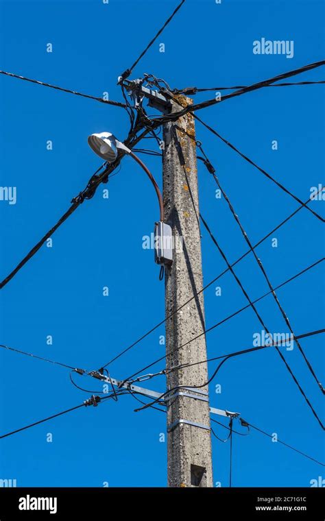 Old Telephone Electrical Wiring And Street Light On Telegraph Pole In