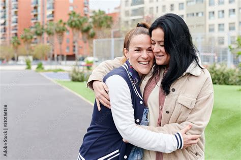 Laughing Lesbian Couple Hugging Together In A Park Stock Photo Adobe Stock