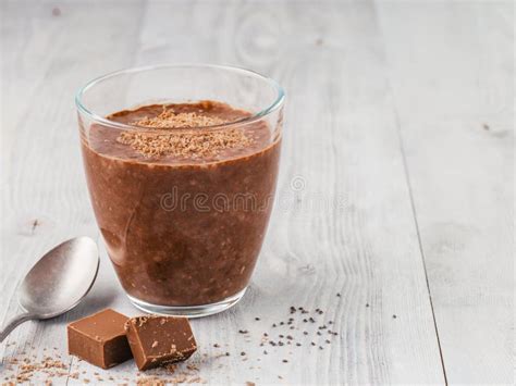 Chocolate Chia Pudding In Portion Glasses On A White Marble Table