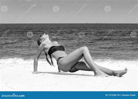 Beautiful Slim Woman In Bikini Lying On Sand On The Beach Stock Photo