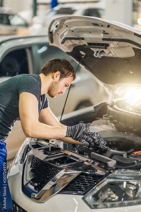 Auto Mechanic Working Under Car Hood In Repair Garage Photos Adobe Stock