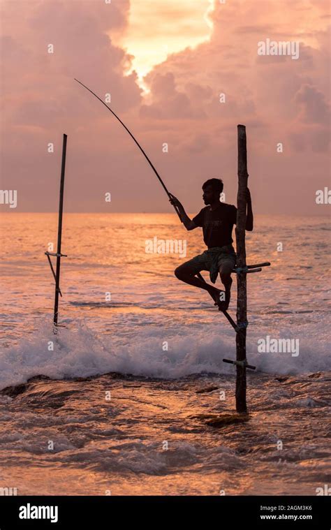 Silhouettes Of The Traditional Sri Lankan Stilt Fishermen On A Stormy