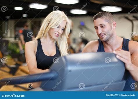 Personal Trainer Helps To Blonde Woman In Gym Stock Image Image Of Beautiful Adult 61974757