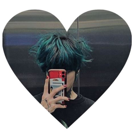 A Woman With Green Hair Taking A Selfie In Front Of A Heart Shaped Mirror