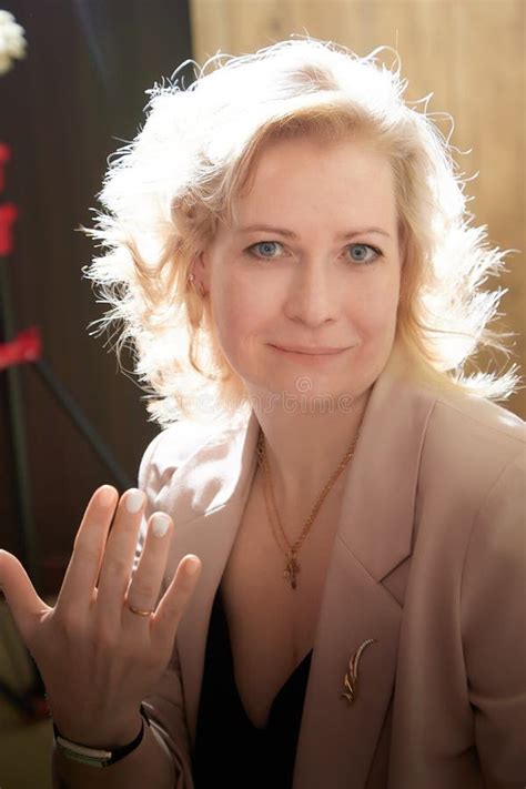 An Adult Blonde Woman In A Beautiful Suit Shows A Ring On Her Finger A Lady Brags About
