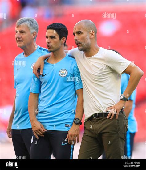 Manchester City Assistant Coach Mikel Arteta Left And Manchester City Manager Pep Guardiola