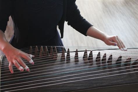 Premium Photo Woman Playing Guzheng Indoors