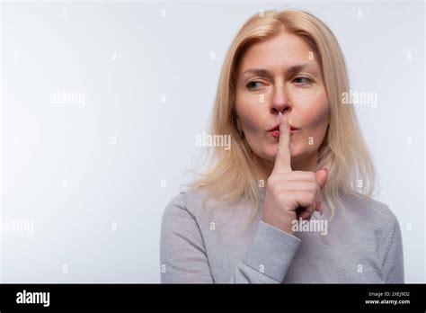 European Woman With Blonde Hair Keeps A Secret Stock Photo Alamy