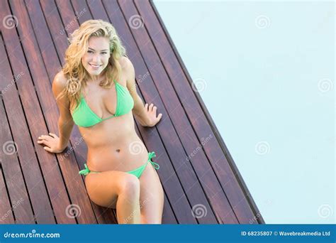 Portrait Of Beautiful Woman In Green Bikini Relaxing By Pool Side Stock