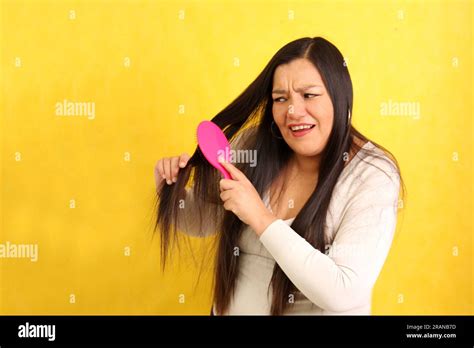 Adult 40 Year Old Latina Woman Brushes Her Hair With Difficulty Because It Is Very Tangled Due