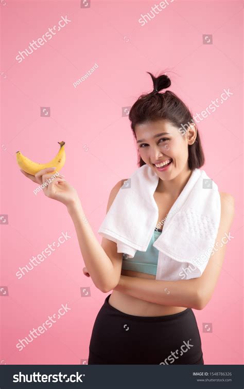 Beautiful Girl Eating Bananas After Exercise Stock Photo