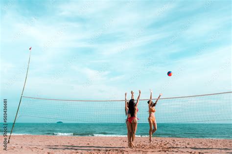 Beautifull Asian Girl Wearing Bikini Play Volleyball On The Sand Beach In A Tropical Location