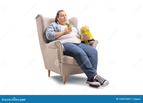 Overweight Woman With A Drink And A Bag Of Chips Sitting In An A Stock