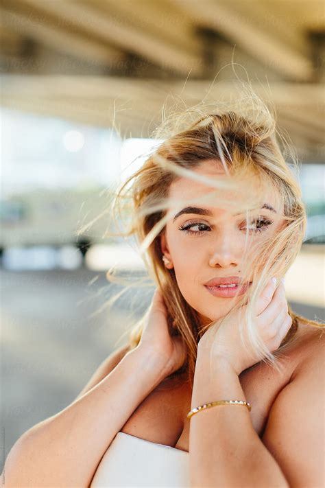 Portrait Of A Beautiful Woman With The Wind Blowing Her Hair In Her