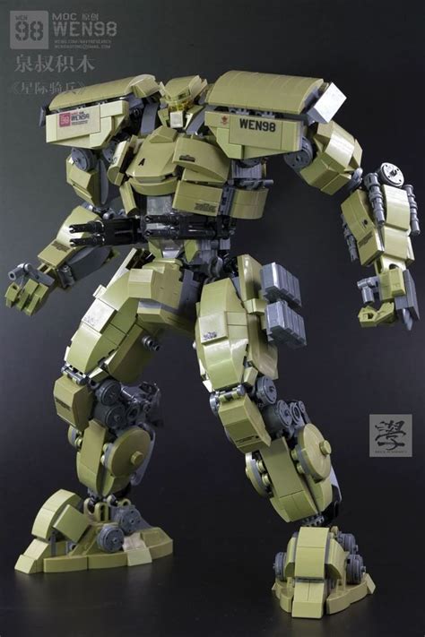 A Green And Black Robot Standing On Top Of A Dark Surface With Words