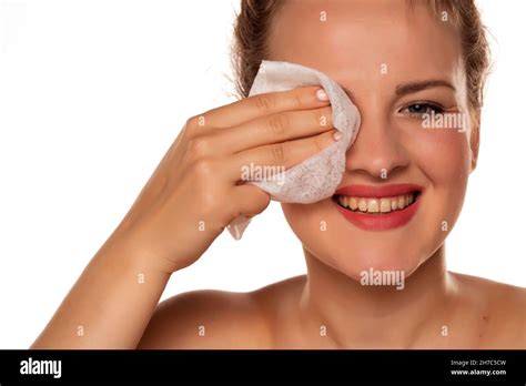 Portrait Of A Blonde Beautiful Smiling Woman Cleans Makeup From Her Face With A Wet Wipe On A