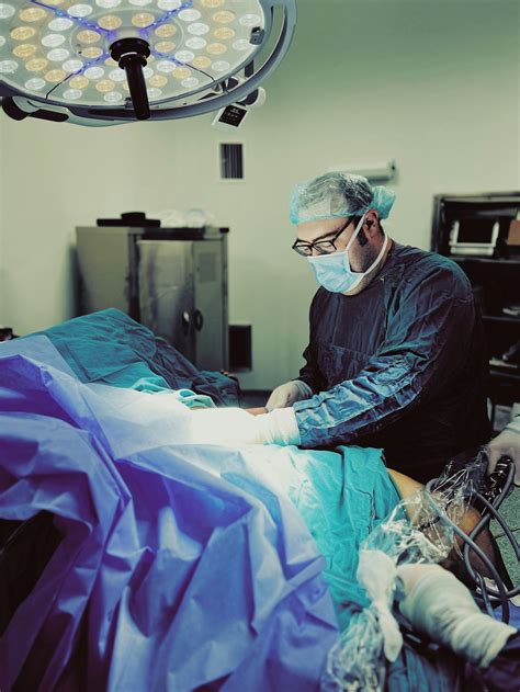 surgeon performing  surgery   operating room  stock photo