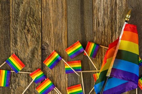 Premium Photo Rainbow Gay Pride Small Flags On Wood Background
