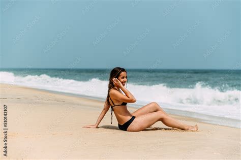Slim Woman In Bikini Standing On Sandy Beach Stock Photo Adobe Stock