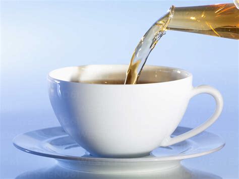 Pouring Tea Into Tea Cup Close Up Stock Photo