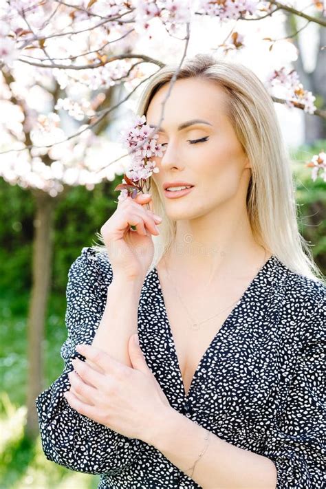 Beautiful Blonde Woman Holding Cherry Blossom In Front Of Her Eye Stock Image Image Of Eyes