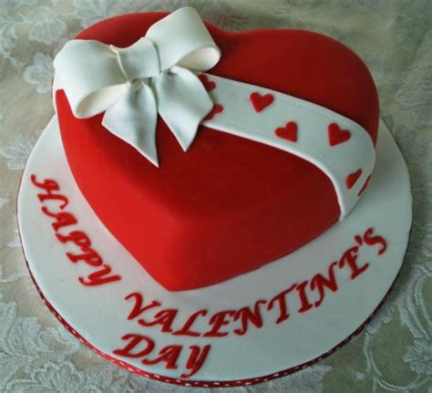 Red heart shaped valentine cake with white cake bow.PNG