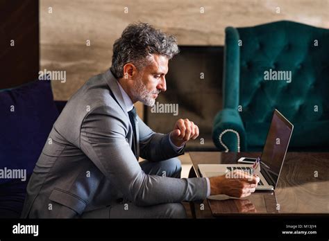 Mature Businessman With Laptop In A Hotel Lounge Stock Photo Alamy