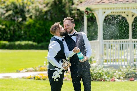 Premium Photo Excited Gay Couple Open Champagne And Kissing On Wedding Day Gay With Partner