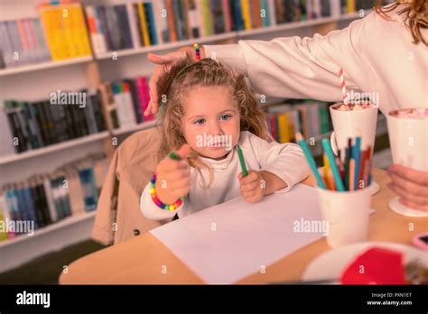 Attentive Blonde Girl Choosing Perfect Color Of Pencil Stock Photo Alamy