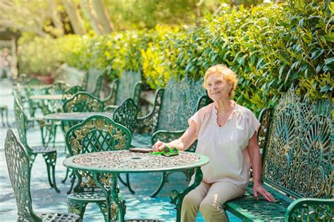 Mature Attractive Woman Traveler Sitting Alone On The Terrace Of Coffee Shop Stock Photo Image