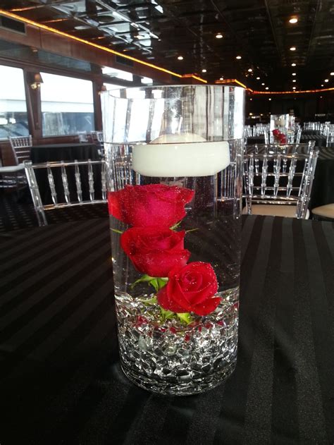 Red Roses Submerged With Floating Candle For A Centerpiece Rose