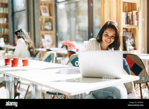 Beautiful Brunette Using Notebook In Cafe Stock Photo Alamy