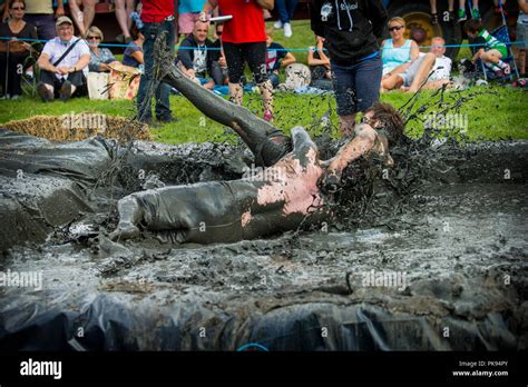 Two Men Mud Wrestling At A Mud Fighting Competition At The Lowland