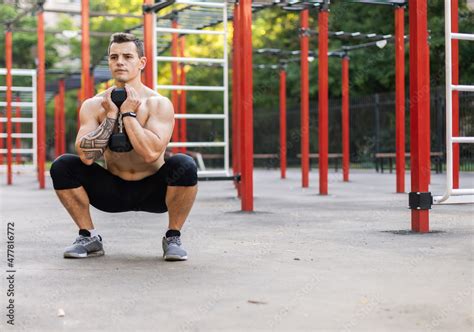 Athletic Male With A Naked Torso Trains With One Dumbbell On Workout Ground Stock Photo Adobe