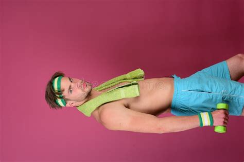 Man With Naked Torso Holds Towel On Neck And Dumbbell Stock Photo Image Of Sport Purple