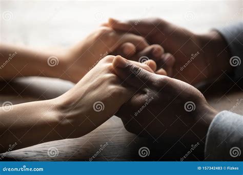 Mixed Ethnicity Couple Holding Hands On Table Close Up View Stock