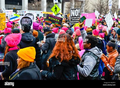 Large Crowd Of Protesters Many Wearing Pink Pussy Hats Holding Anti Trump Policy Signs In