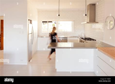 Woman Walking In Kitchen Stock Photo Alamy