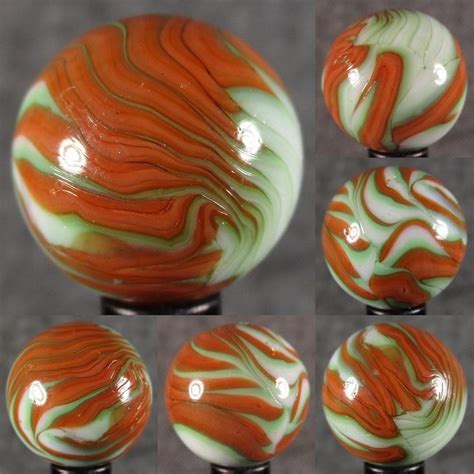 An Assortment Of Glass Knobs With Orange And White Swirled Designs