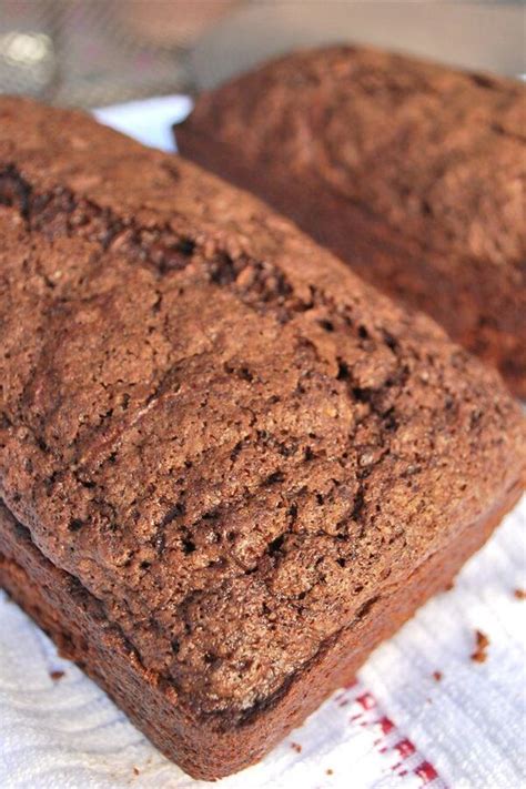 Two Brown Breads Sitting On Top Of A White Paper Towel Next To Each Other