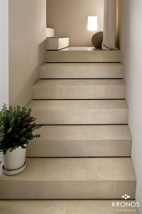 There Is A Plant On The Stairs In This House With White Walls And Flooring