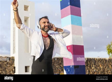 A Transvestite Gay Man Exudes Happiness While Dancing And Listening To Music Outdoors His Joyful