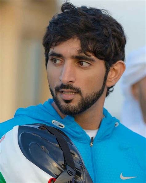 A Close Up Of A Person Wearing A Jacket And Holding A Motorcycle Helmet