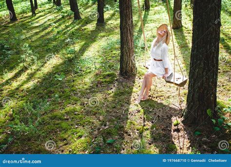 Blond Woman With Slender Beautiful Naked Legs Sitting With On A Rope Swing Stock Photo Image