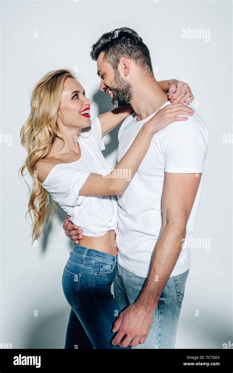 Happy Blonde Woman Hugging Cheerful Bearded Man On White Stock Photo Alamy