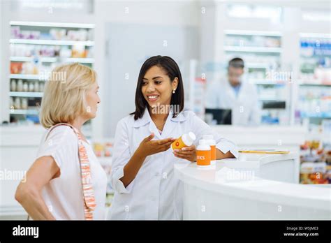 Positive Delighted Brunette Consultant Working With Client Stock Photo Alamy