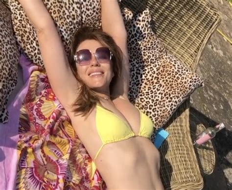 Elizabeth Hurley Celebrates The Last Of The September Sun In Bright Yellow Bikini